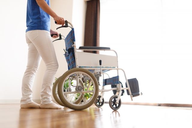 車椅子を押す介護福祉士